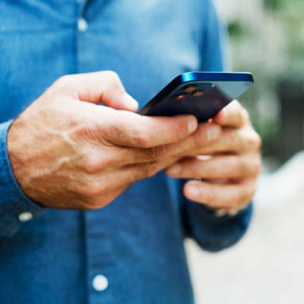 Close shot of a man holding a mobile phone