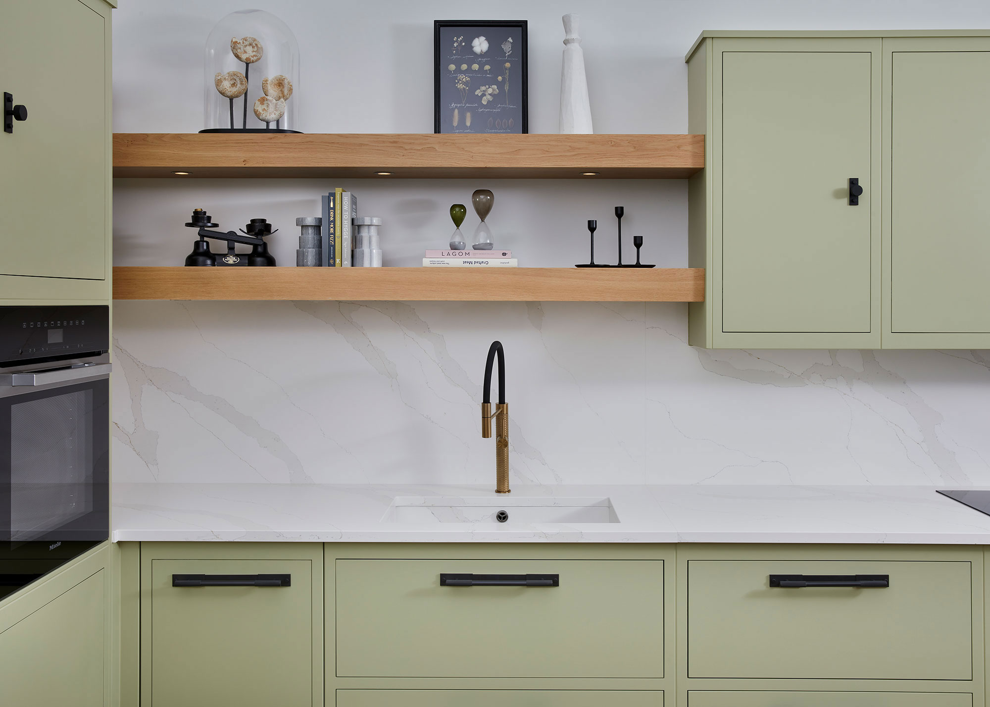 pale green kitchen with wooden open shelving