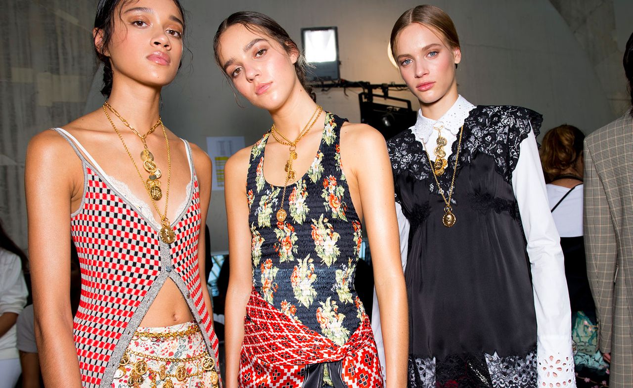 Models wear red checked top, black floral dress and black dress with white top