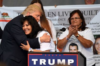 Donald Trump embraces a woman at a campaign event