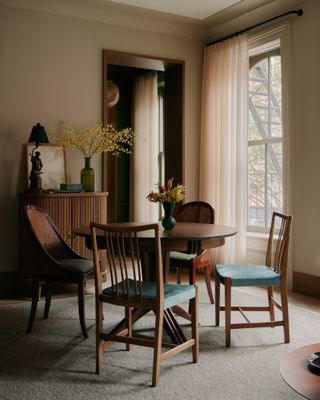 Dining room with moody magnolia walls and dark wood table and chairs