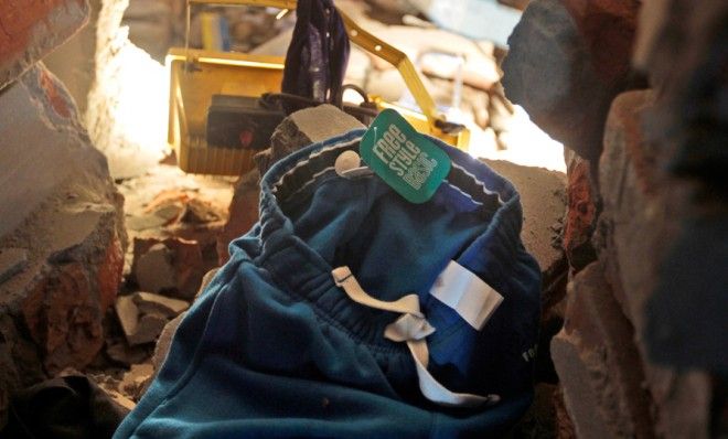 A piece of clothing with the label tag still intact lies in the rubble of a building that collapsed on April 24.