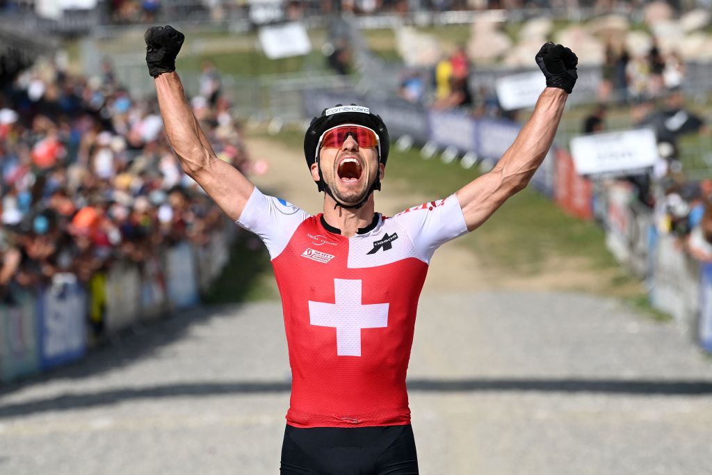 Swiss cyclist Nino Schurter celebrates after winning the men&#039;s elite olympic cross-country event at the UCI Mountain Bike World Championships 2022 in Les Gets, south-eastern France, on August 28, 2022. (Photo by OLIVIER CHASSIGNOLE / AFP) (Photo by OLIVIER CHASSIGNOLE/AFP via Getty Images)