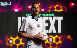 Tottenham and England striker Harry Kane holding a football as his partnership with TOCA Football is announced