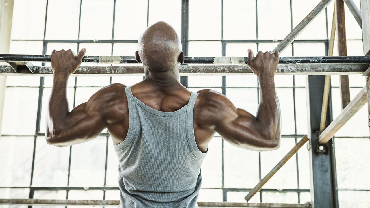 Athletic person performing a pull-up