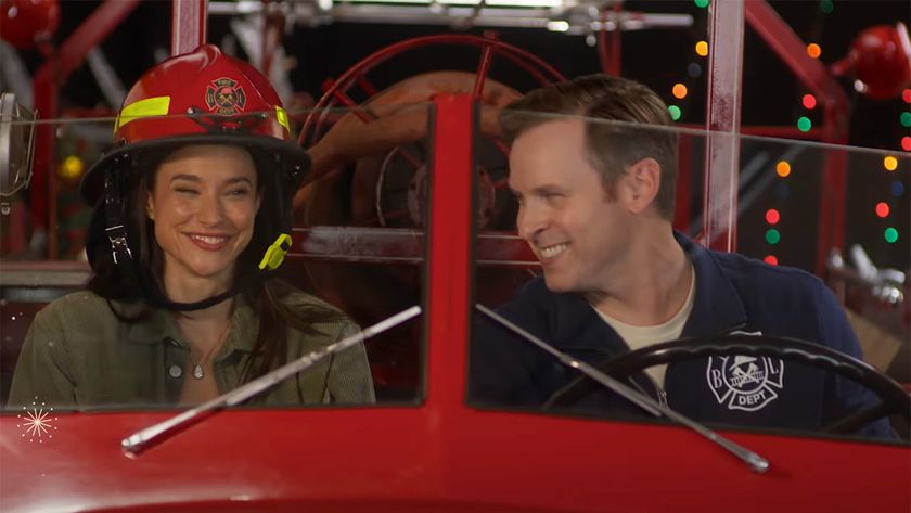 Rhiannon Fish sits in a vintage fire truck with her When Calls The Heart Co-Star Ben Rosenbaum 