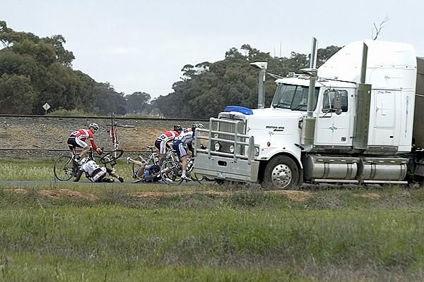 Riders tangle themselves up under the watchful eye of a truck driver on stage three.