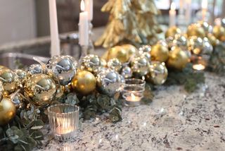 garland decorated with gold and silver ornaments on marble table