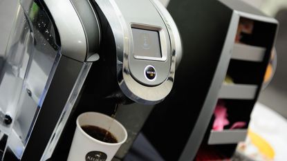 Close up of a black and silver Keurig coffee machine