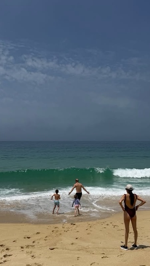Screenshot of a picture posted by the Duchess of Sussex on Instagram, showing her, Prince Harry and their children on the beach
