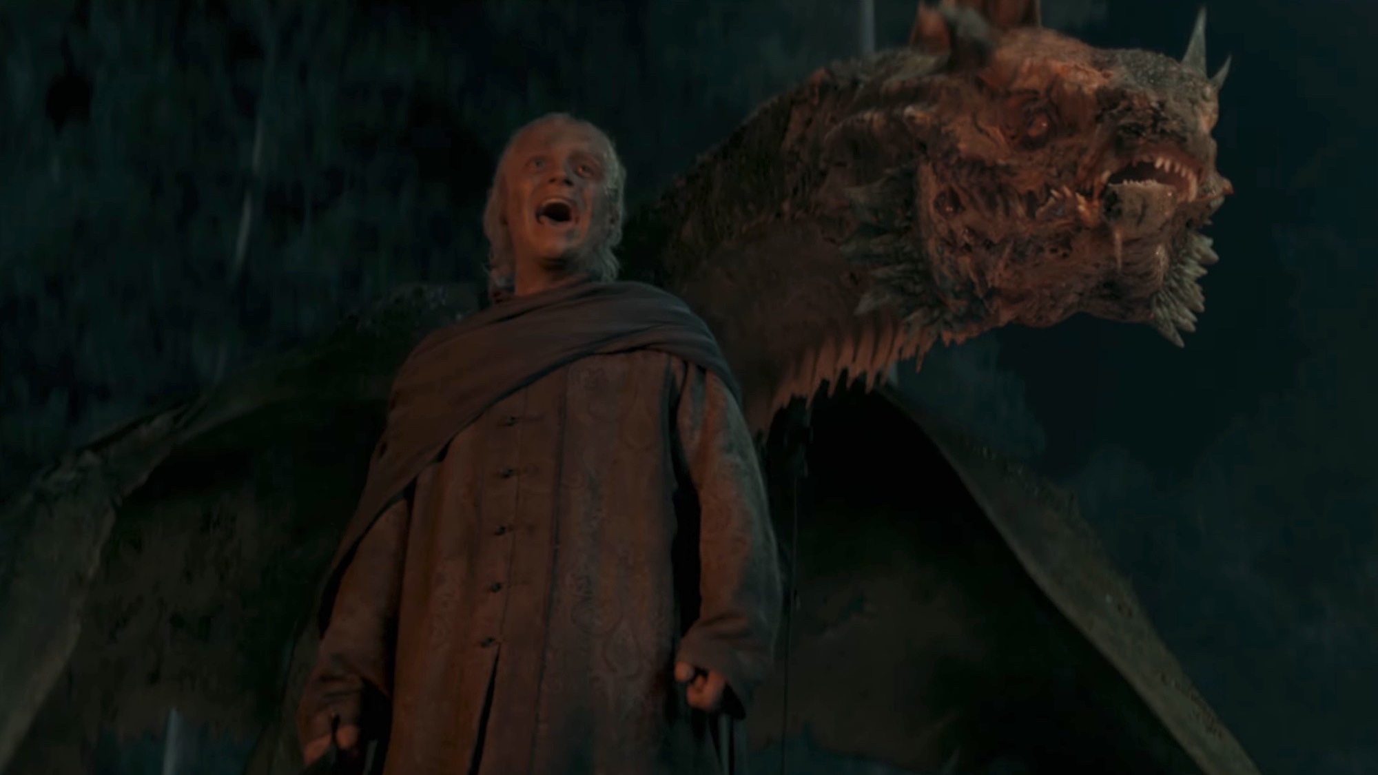 A maimed Sunfyre standing behind Aegon.