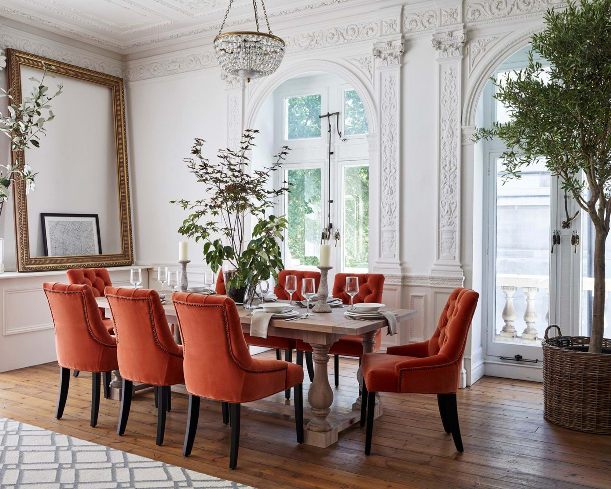 White dining room with coral red velvet chairs