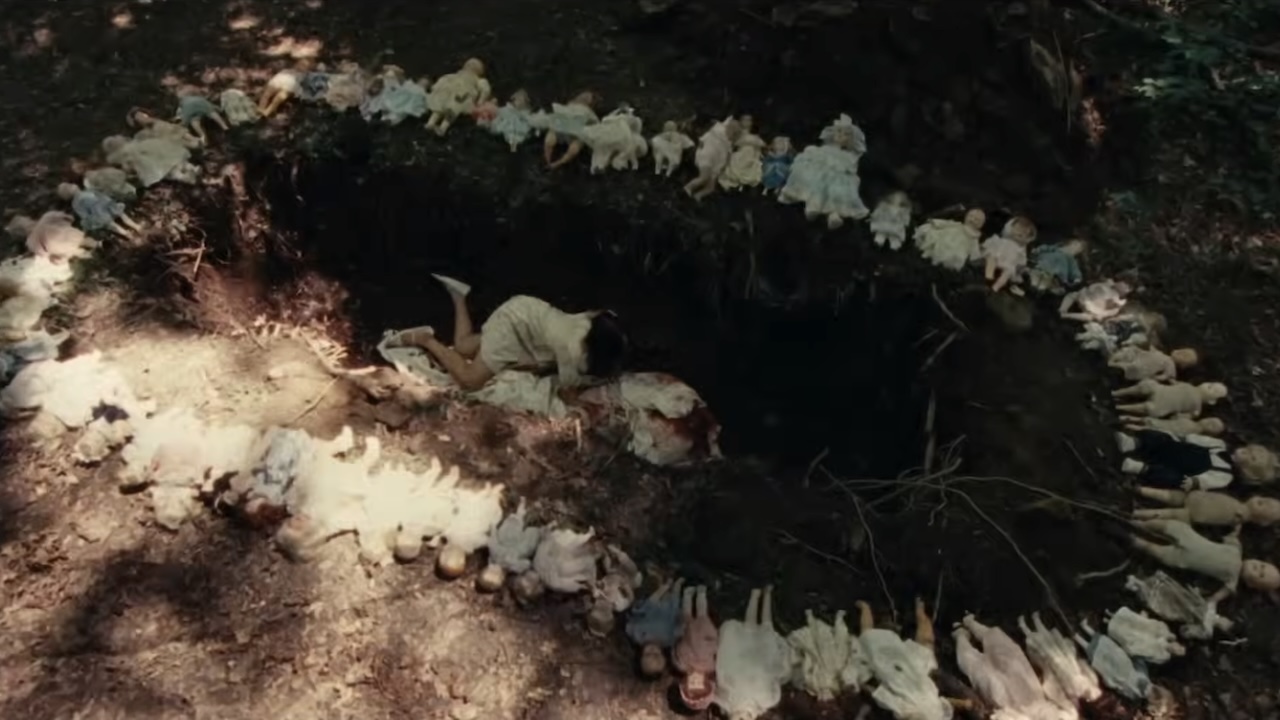 Dolls surrounding large grave site in Dolly
