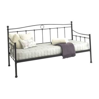 Steel frame bed with white mattress and pillows