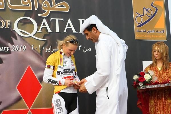 Rasa Leleivyte (Safi-Pasta Zara) is helped into the race leader's gold jersey.