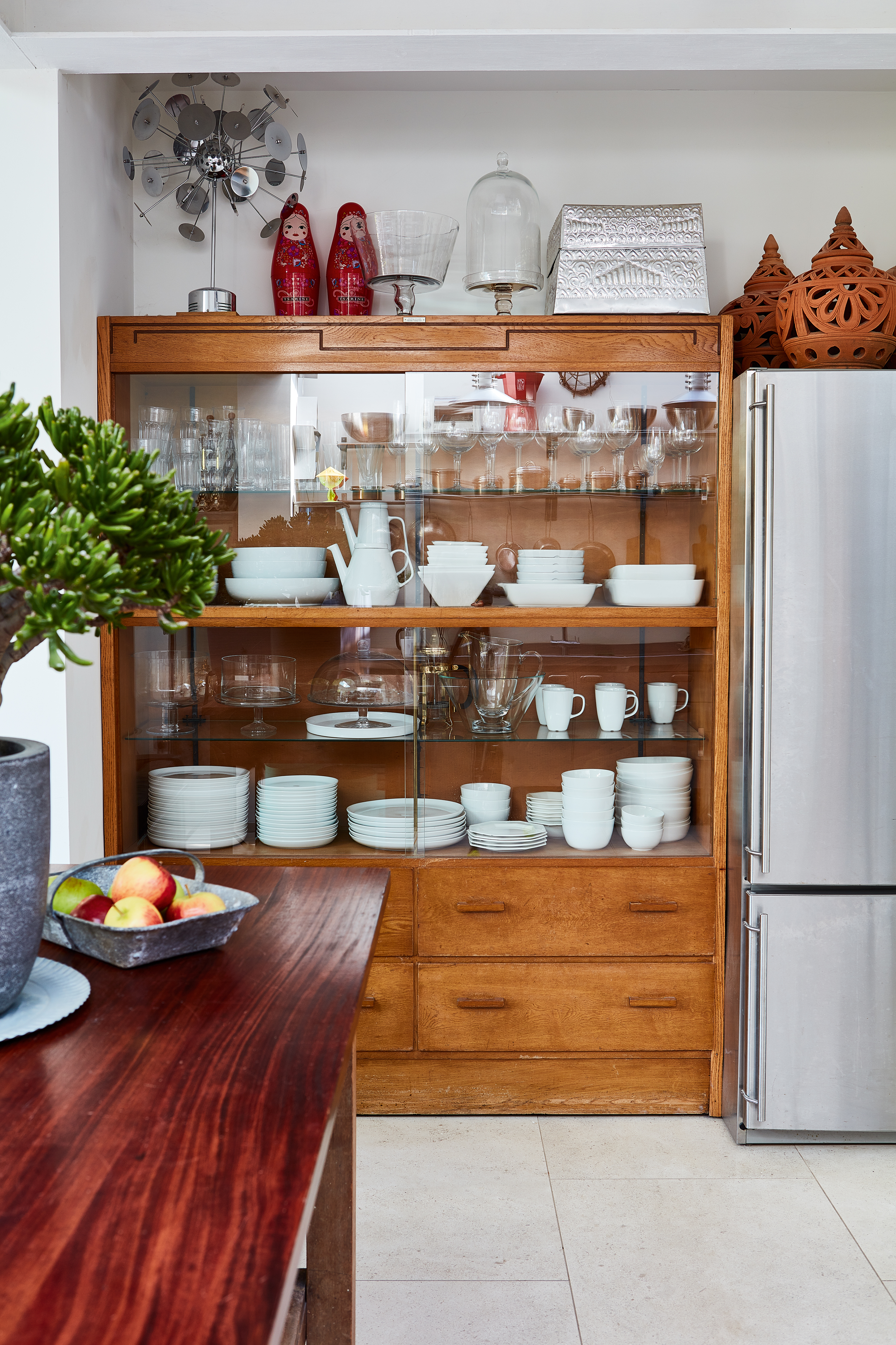 Vintage glazed dresser unit in an industrial style kitchen extension