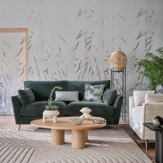Green large sofa in boho decorated living room with wood accents