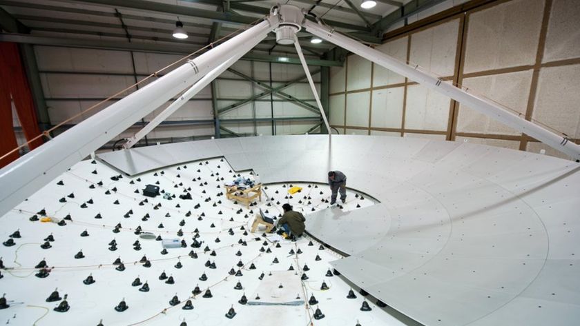 A large antenna dish is half covered by smooth surface panels while the other half is covered by small spikes.