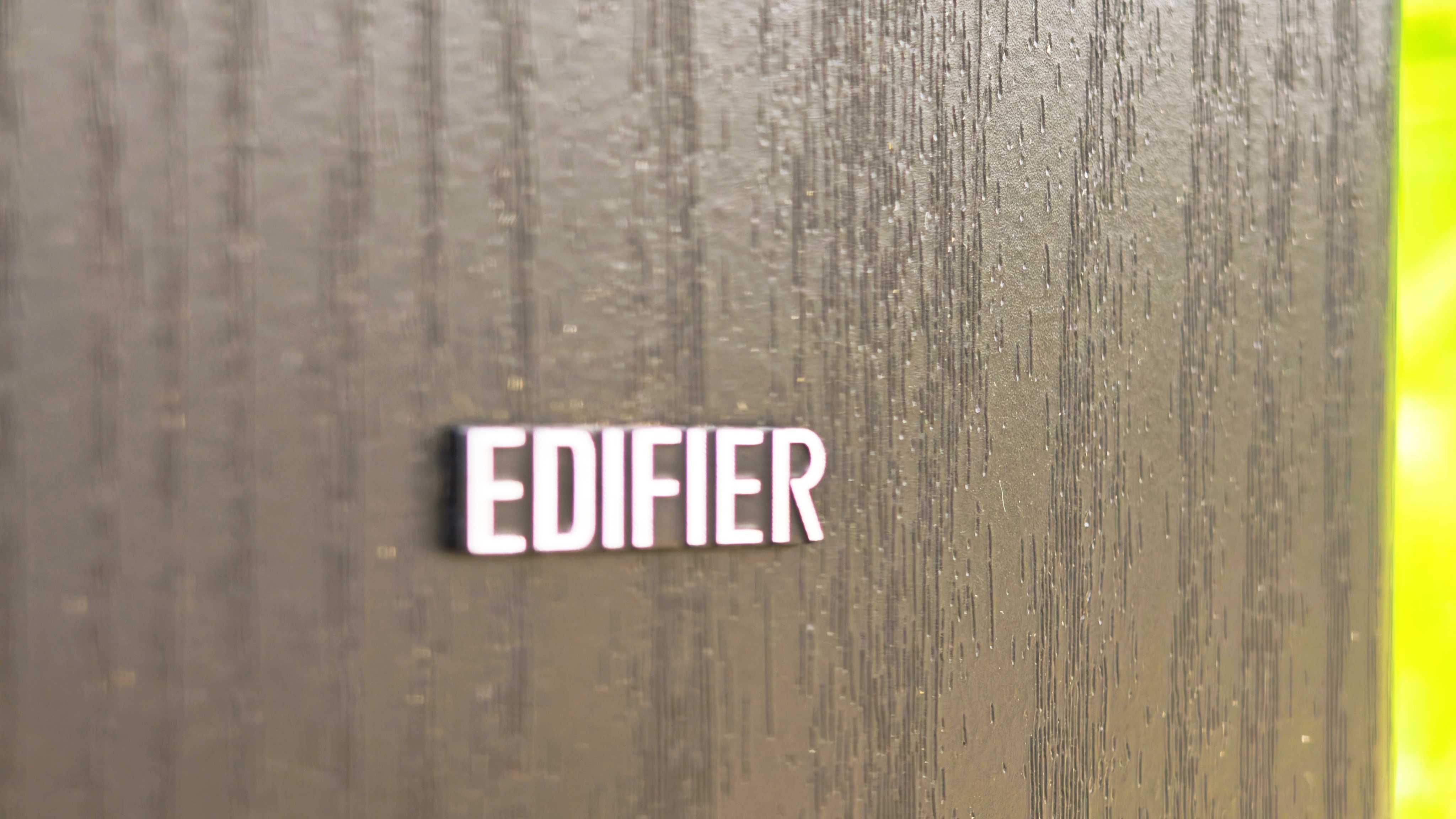 Edifier T5s subwoofer on a green garden lawn