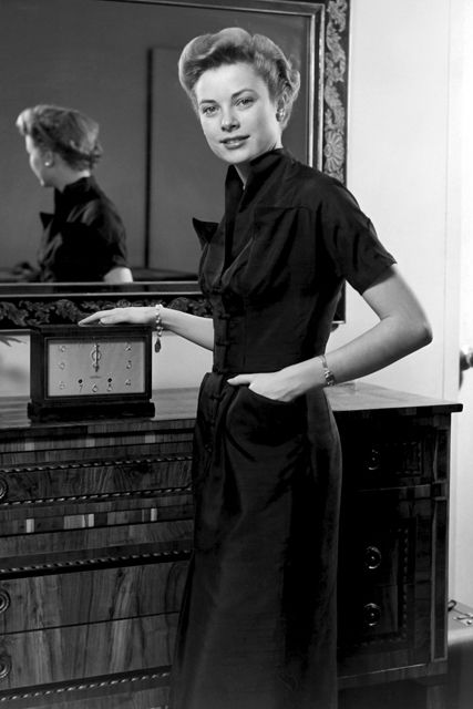 Grace Kelly poses in front of a mirror