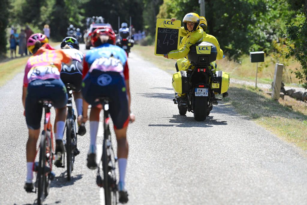 BLAGNAC, FRANCE - JULY 28: An assistant shows on a blackboard the time difference with the peloton to Sandra Alonso of Spain and Team CERATIZIT-WNT Pro Cycling, Agnieszka Skalniak-S&Atilde;&sup3;jka of Poland and Team Canyon//SRAM Racing and Emma Norsgaard of Denmark and Movistar Team while compete in the breakaway during the 2nd Tour de France Femmes 2023, Stage 6 a 122.1km stage from Albi to Blagnac / #UCIWWT / on July 28, 2023 in Blagnac, France. (Photo by Tim de Waele/Getty Images)