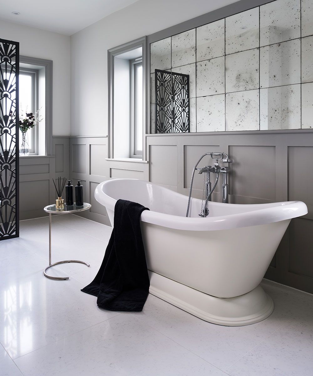 bathroom with freestanding roll top bath and tile floor