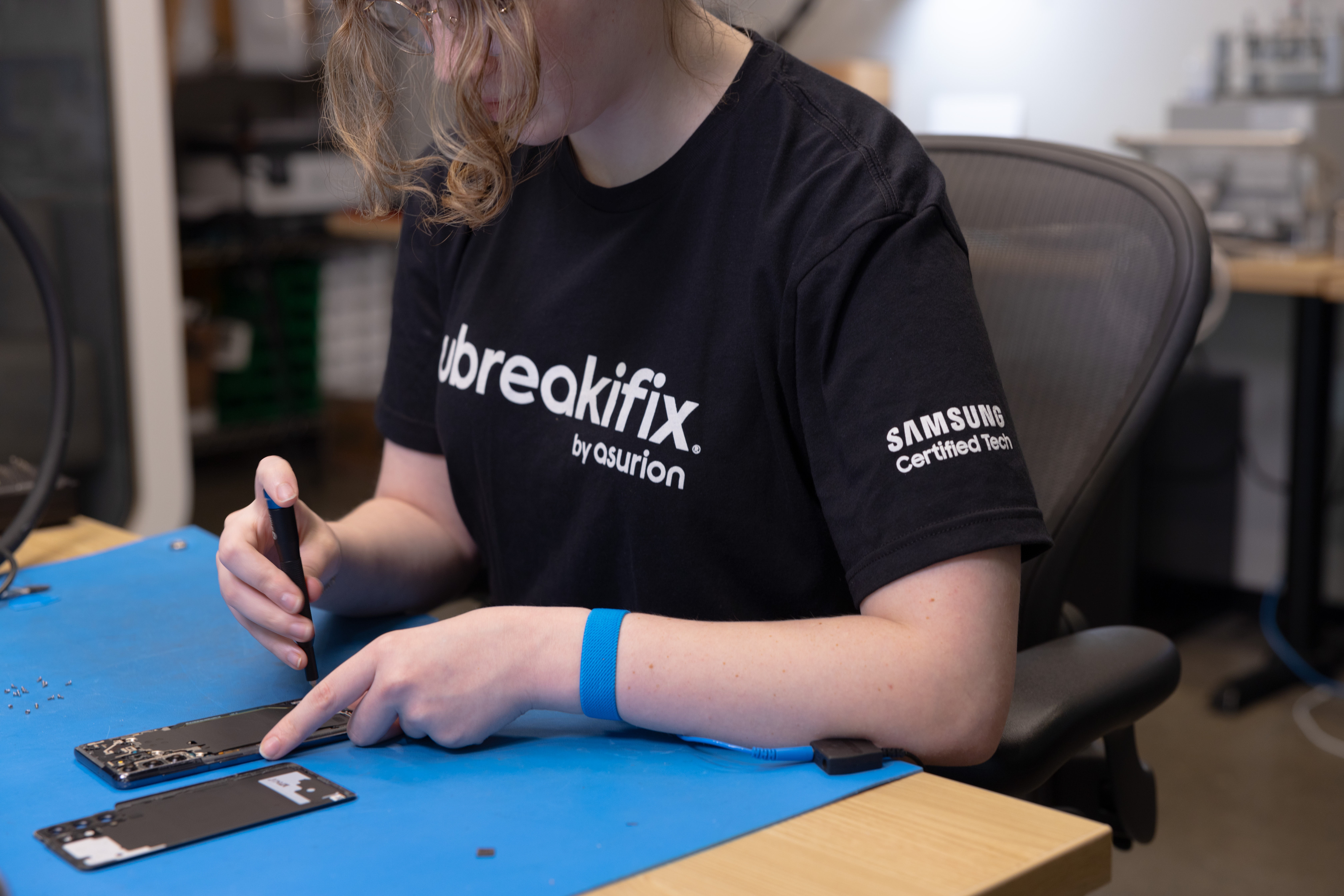 A technician repairing a phone at one of Samsung's flagship repair stores.