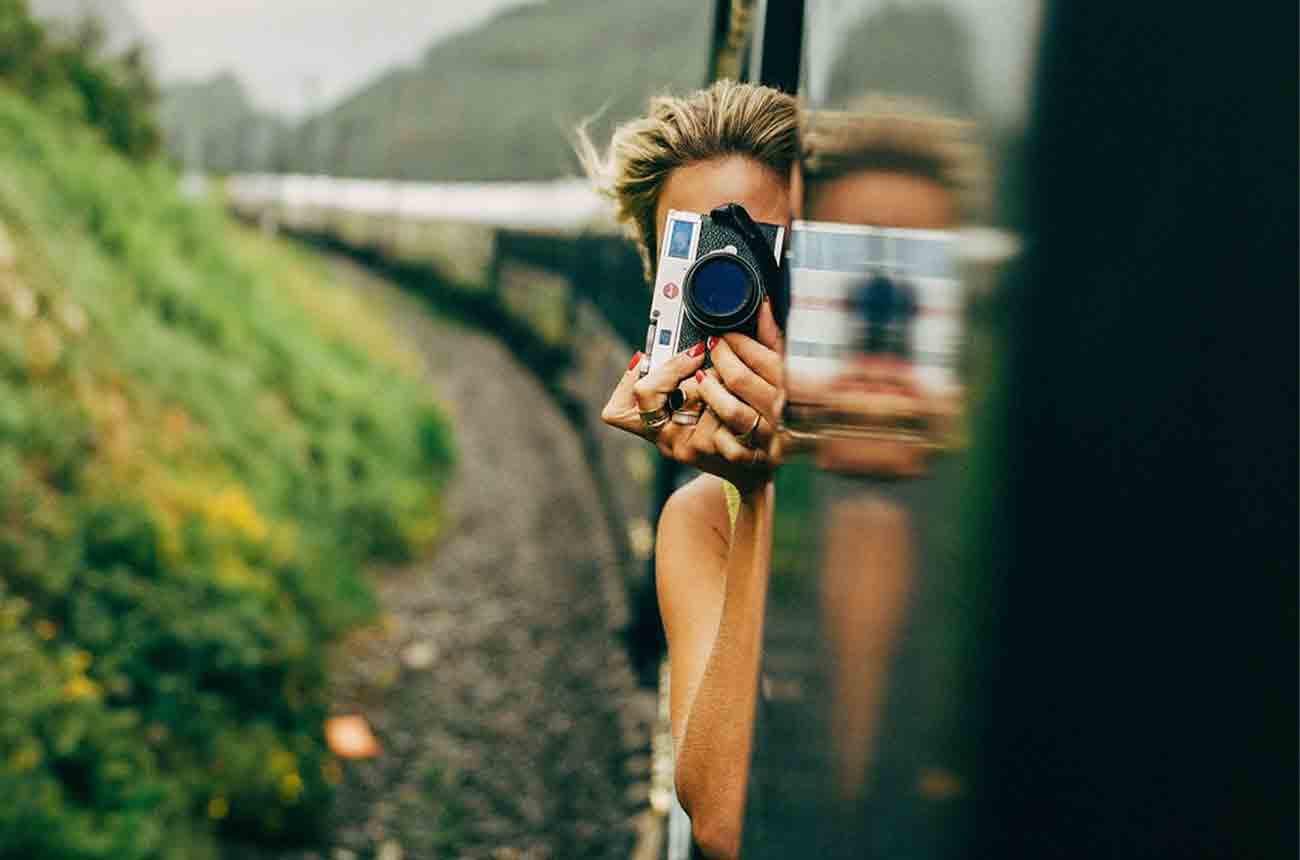 Lady photographer onboard Veuve Clicquot's Solaire Journey on Belmond train.