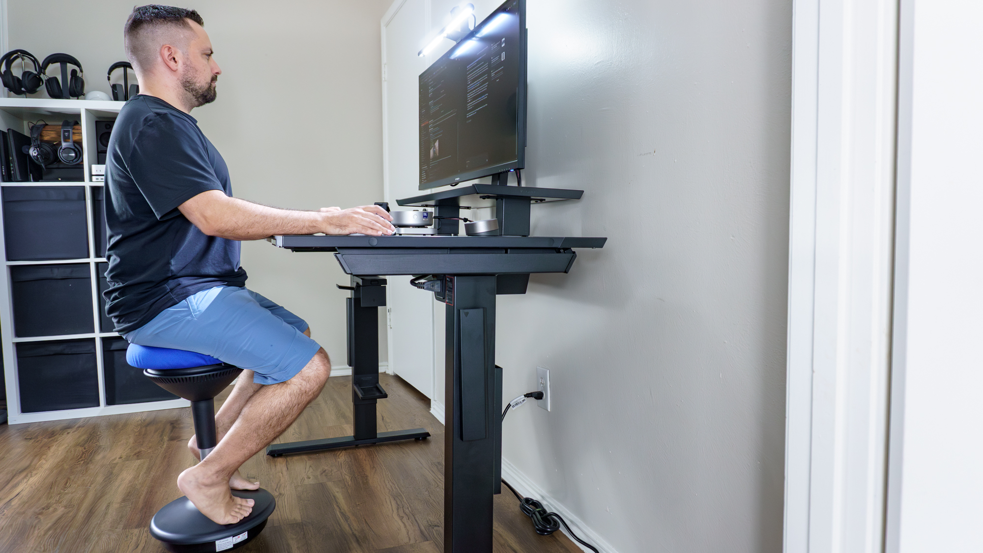 A person sitting at their desk working on a wobble stool