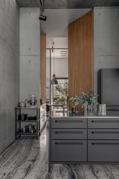 This brutalist home features a dramatic matte black kitchen | Livingetc