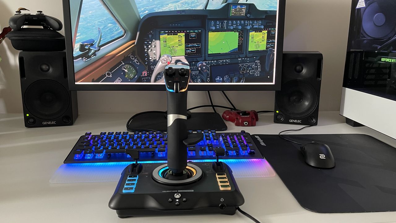 Turtle Beach VelocityOne Flight Stick in front of PC displaying flight simulator game