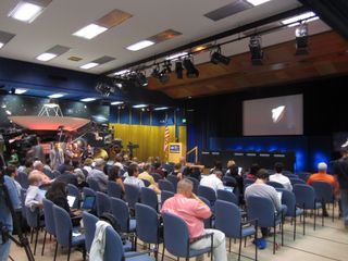 Reporters and assorted guests watch the NASA TV feed at JPL shortly before the Curiosity rover touched down on Mars on Aug. 5, 2012.