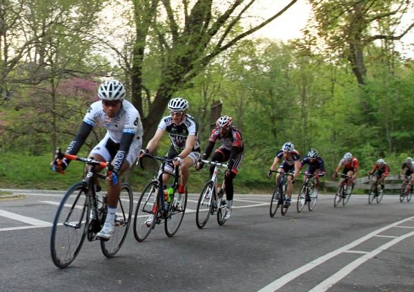 Cresting the hill, Cesar Martes (GC Mengoni) leads the peloton.