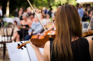 A violin player performing for a crowd