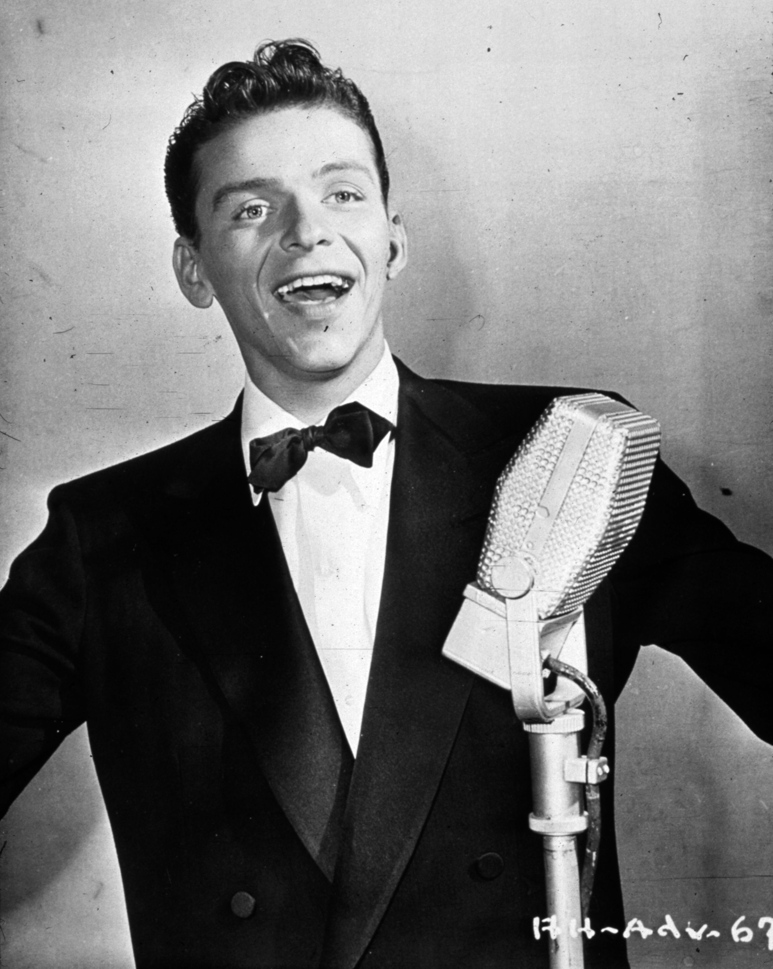 circa 1935: Popular American singer and actor Frank Sinatra (1915 - 1998) exercises his golden tonsils.