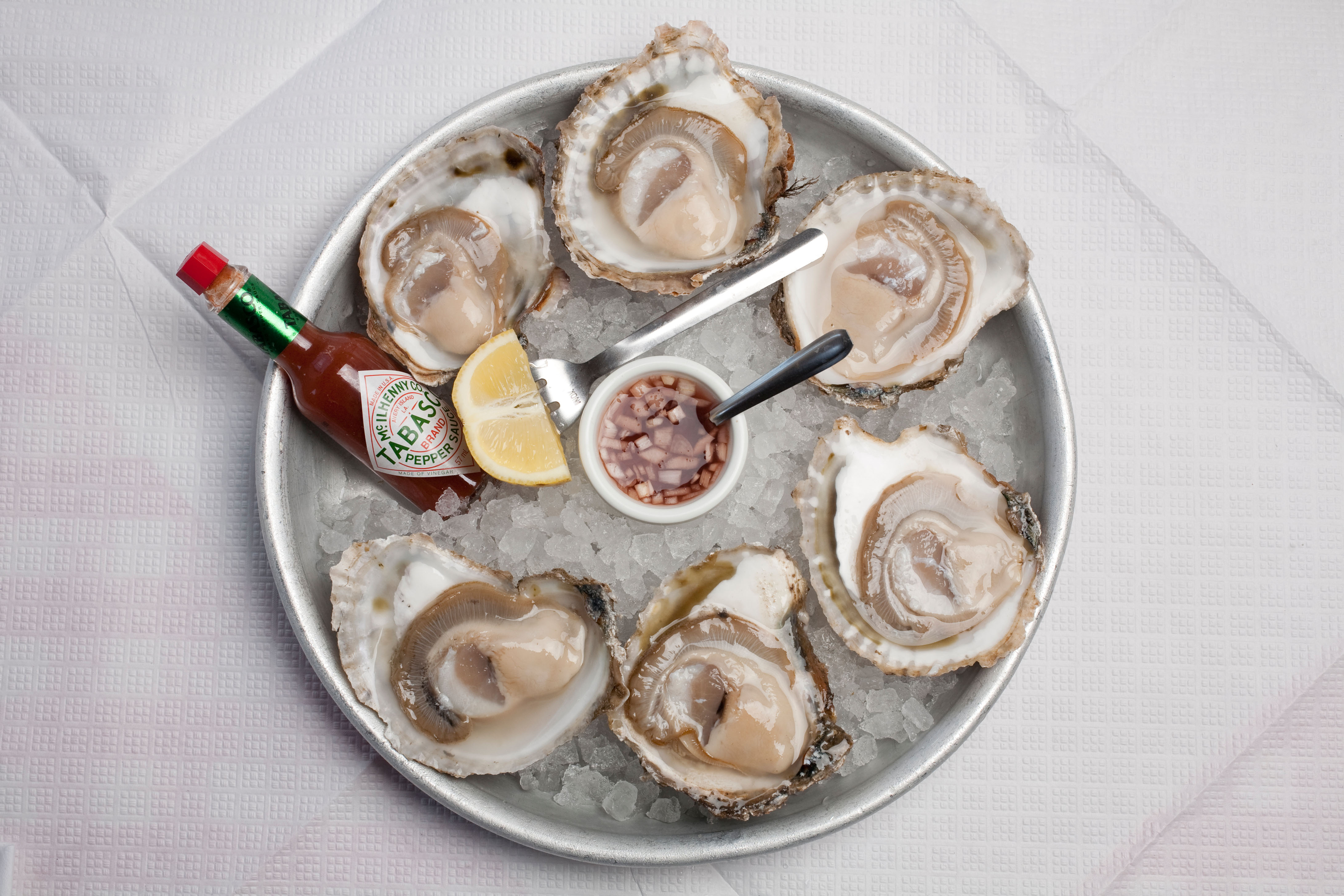 Plate of oysters and garnishes