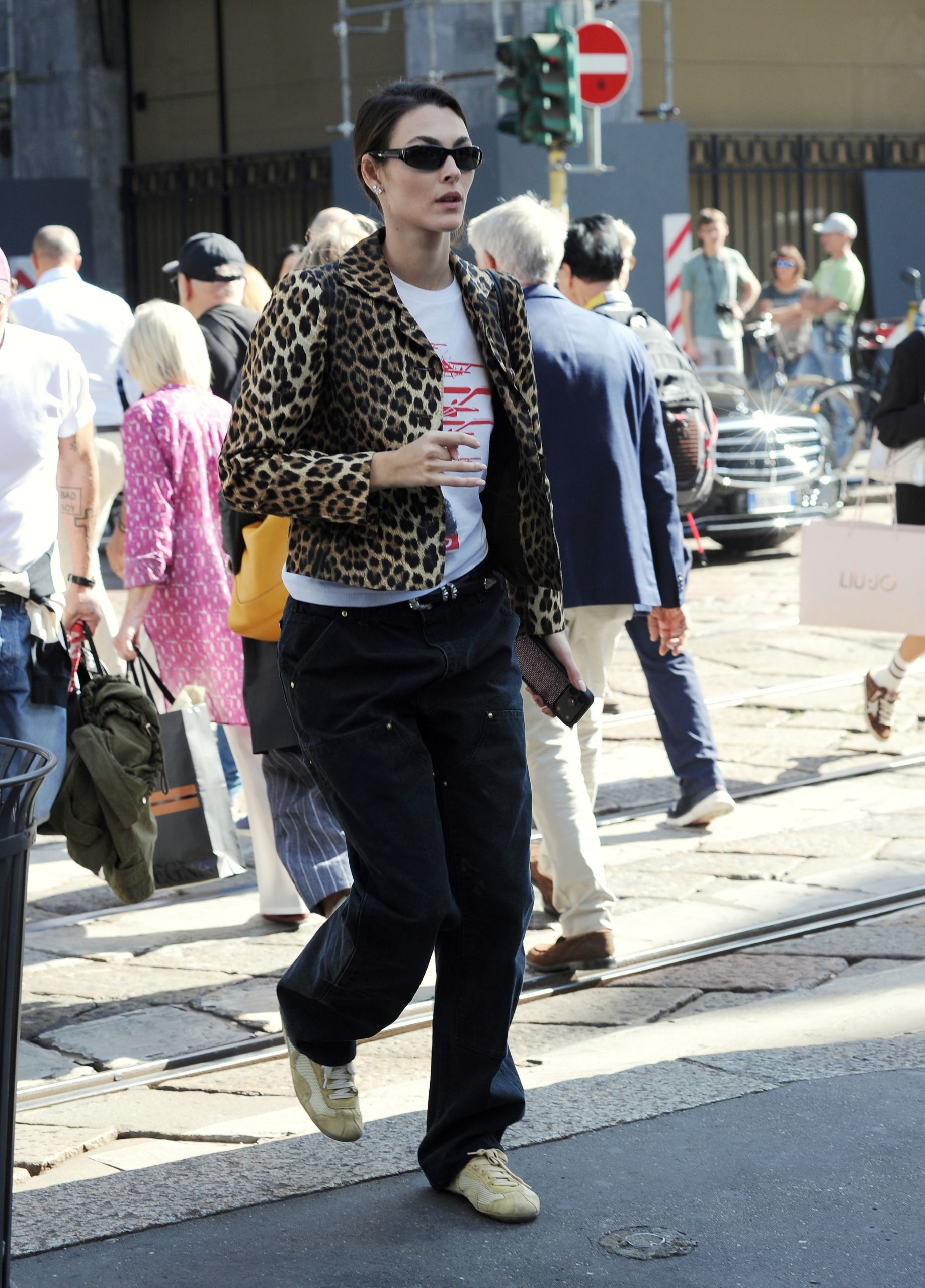 Vittoria Ceretti photographed in Milan between shows during Milan Fashion Week wearing Prada Montecarlo Re-Edition 2005 Suede-Trimmed Mesh Sneakers in yellow.