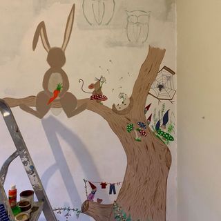 nursery wall painted with tree and rabbit