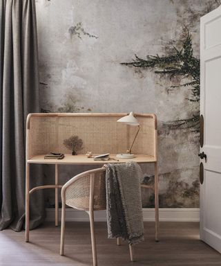 wooden desk with chair and neutral patterned wallpaper