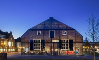 Architectural firm MVRDV’s Glass Farm disguises a glass office complex as an old farmhouse.