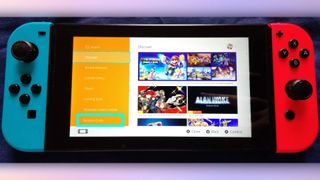 A photo of a Nintendo Switch console. The "redeem code" option is highlighted.