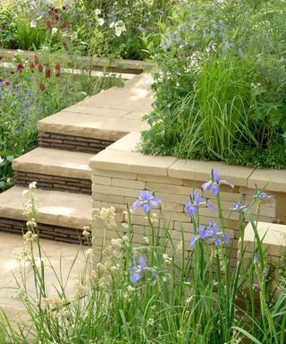 flagstone pathway and steps surrounded by planting