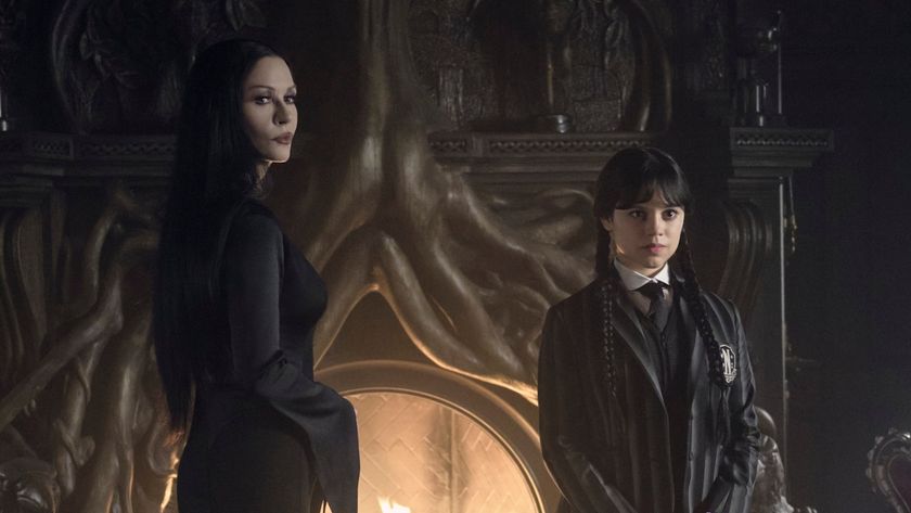 Morticia and Wednesday standing in front of fireplace in Wednesday Season 2