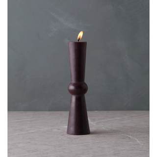 deep purple candle with a slim straight and sculptural shape