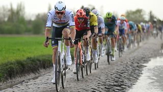 Mathieu van der Poel leads the peloton on cobbled roads during the 2024 Paris-Roubaix.