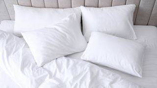 Four pillows at the top of a bed