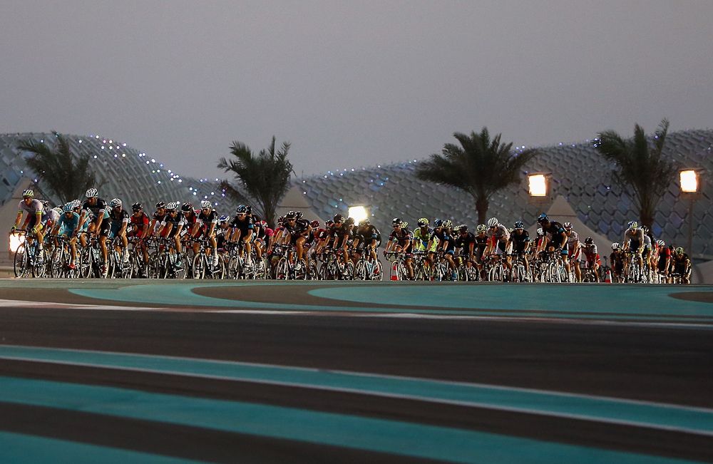 The peloton racing under the lights in Abu Dhabi.