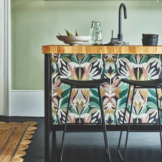 kitchen island with colourful wallpaper