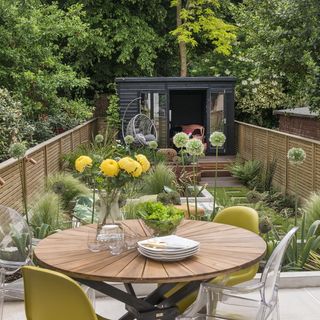 dinning table and chairs in garden with plants