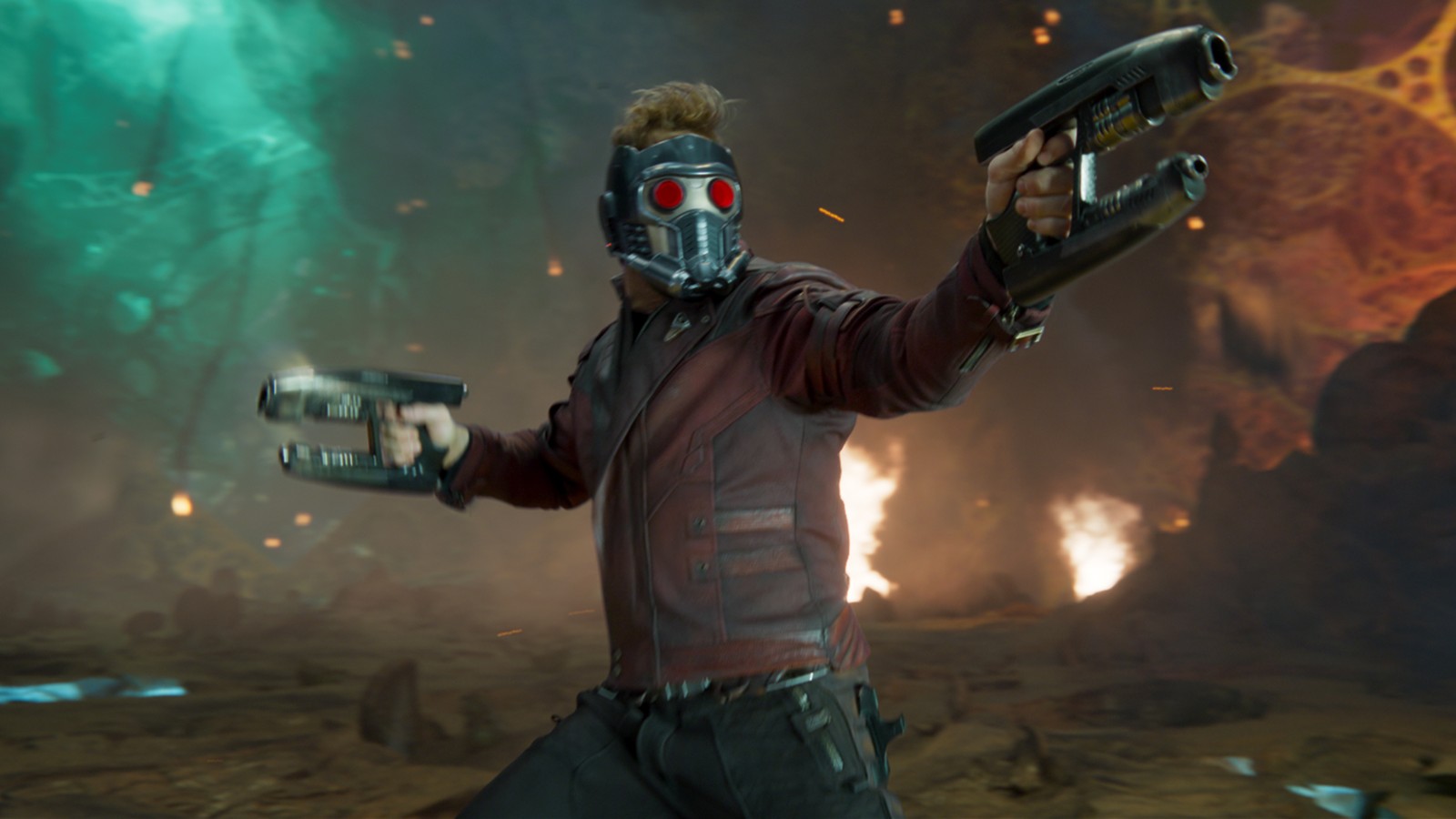 Movie still from Guardians of the Galaxy Vol.2. Here we see Star-Lord in an action pose with his visor up and holding two space pistols.